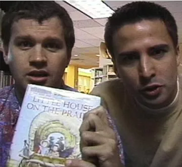 Shane and Craig holding a Little House on the Prairie book